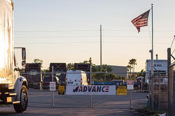 Trcuk parking lot gate with Advance logo